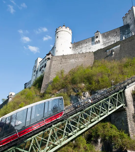 Modern funicular railway ascending to Hohensalzburg Fortress on a sunny day